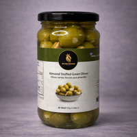 Jar of almond-stuffed green olives with a label on a gray background