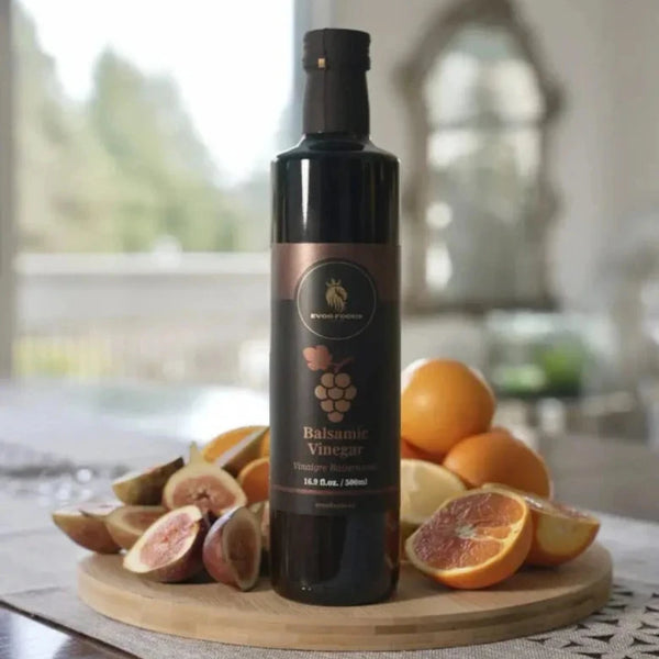 Bottle of Balsamic Vinegar on a wooden board with fruits in a kitchen setting