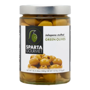 A jar of green olives on top of a table.