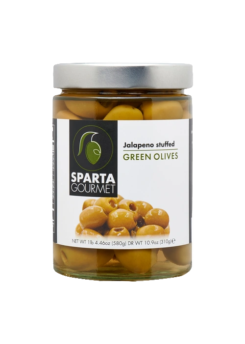 A jar of green olives on top of a table.